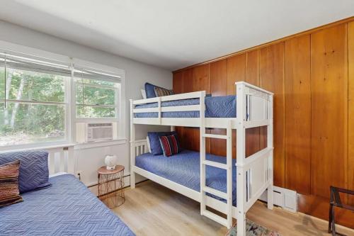 a bedroom with two bunk beds and a bed at Topside Garden in North Conway
