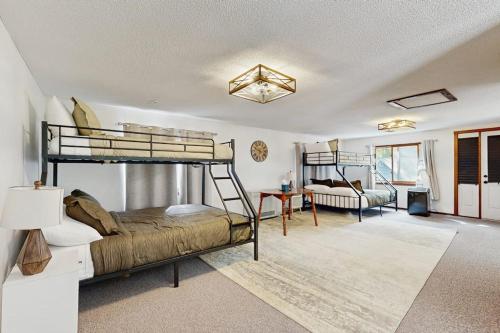 a bedroom with two bunk beds and a living room at Ski & Splash Retreat in Bridgton