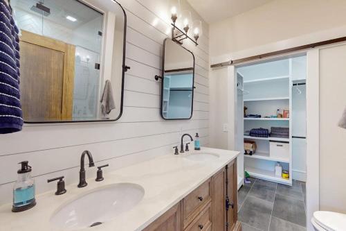 a bathroom with two sinks and a mirror at We'll Ski in Jackson