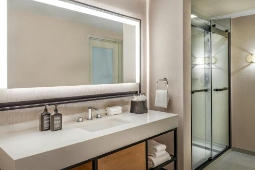 a bathroom with a sink and a mirror at Sheraton Commander Hotel in Cambridge