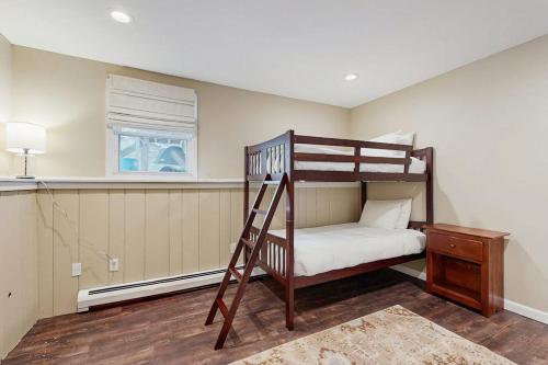 a bedroom with a bunk bed with a ladder at White Mountain Trailhead in Campton