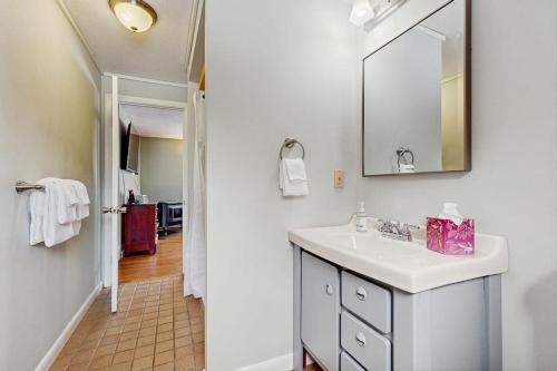 a white bathroom with a sink and a mirror at White Mountain Trailhead in Campton