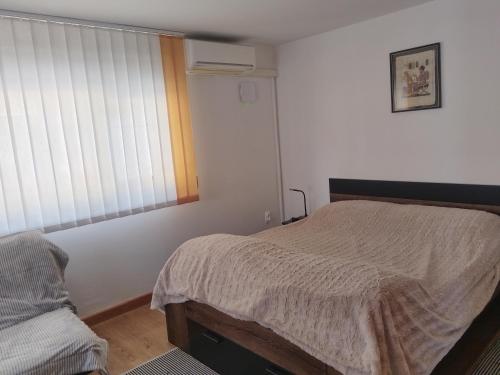 a bedroom with a bed and a window at apartma Grad in Motnik