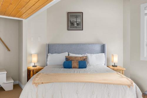 a bedroom with a large bed with two lamps at West Willow 5 in Telluride