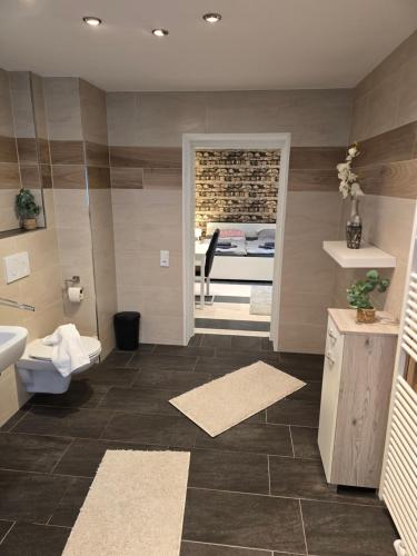 a bathroom with a sink and a toilet and a sink at Gästehaus an der Bode wahlweise mit Halbpension PLUS in Braunlage