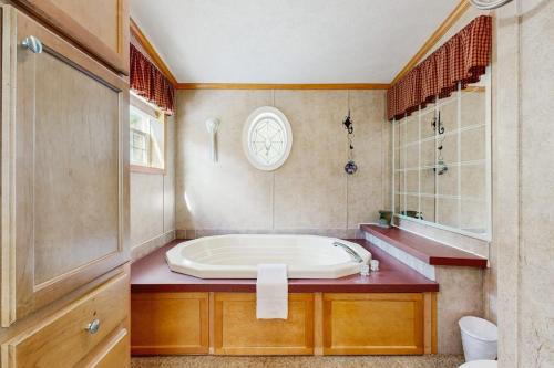 a bathroom with a large tub on a counter at Hillside Hideaway in North Woodstock
