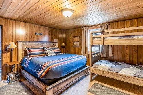 a bedroom with two bunk beds in a cabin at Bay Point Lakefront 1B Down in Whitefish