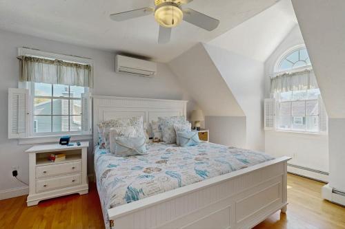 a bedroom with a large bed and two windows at York Starfish Haven in York
