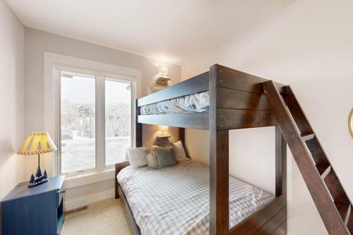 a bedroom with a bunk bed and a window at Saddle Ridge B2 in Big Sky