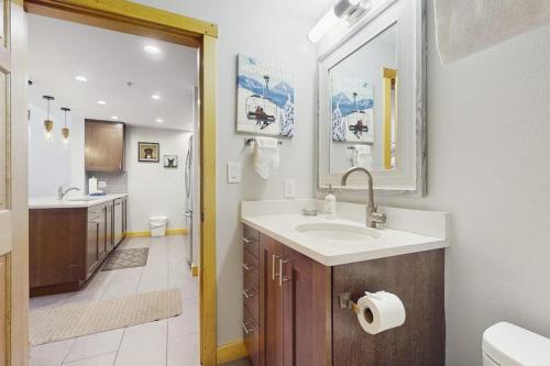 a bathroom with a sink and a mirror at Passage Point 422 in Copper Mountain