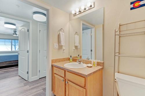 a bathroom with a sink and a mirror at First Tracks Fun in Steamboat Springs