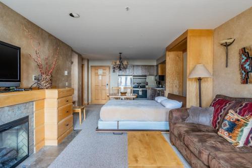 a living room with a bed and a couch at Shoshone 1960 in Big Sky