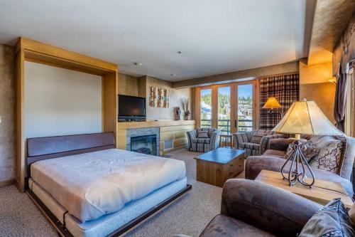 a bedroom with a bed and a living room at Shoshone 1954 in Big Sky