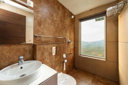 a bathroom with a sink and a window at The Cloud by Daan in Vagamon