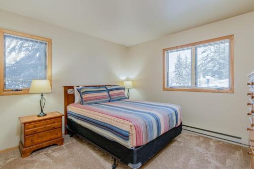 a bedroom with a bed and two windows at 513 Cache in Jackson