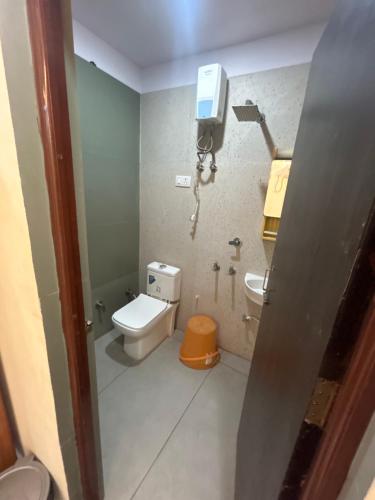 a small bathroom with a toilet and a sink at Hotel sunshine in Kānpur