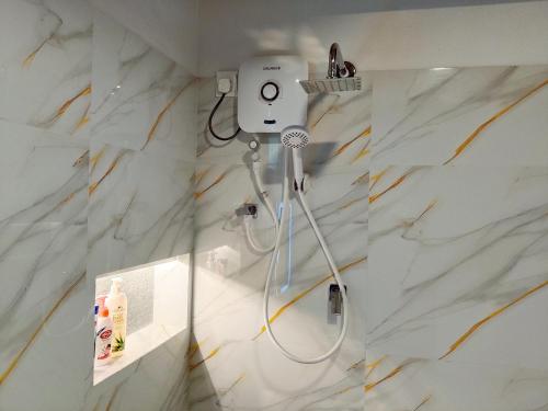 a white marble bathroom with a shower in it at Haven Crest Sinharaja in Deniyaya