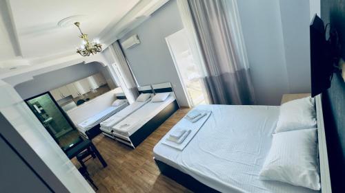 a bedroom with a large white bed and a window at Grand Hotel Kobuleti in Kobuleti