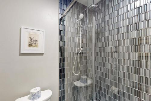 a bathroom with a shower with a sink and a toilet at 2404 Pitchfork in Jackson