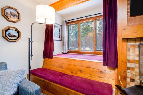 a room with a window with a purple bench in a room at 3614 Winterberry in Wilson