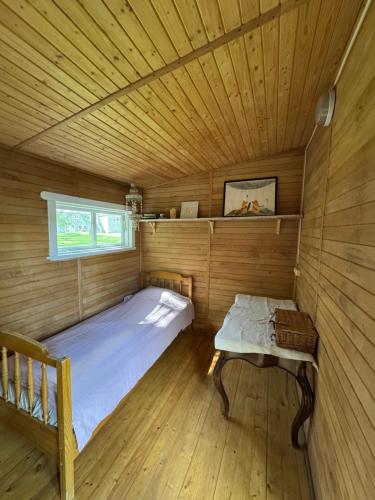 a room with a bed and a bench in a sauna at The lake house in Mockava