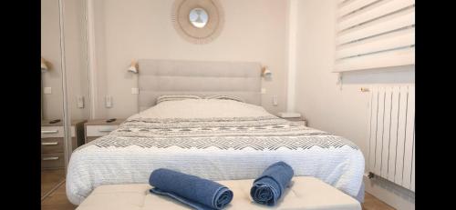 a bedroom with a bed with two blue towels on it at Mandelieubeach06 in Mandelieu-La Napoule