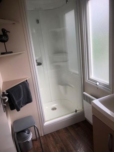 a bathroom with a shower and a sink at Omaha beach mobilhome in Colleville-sur-Mer