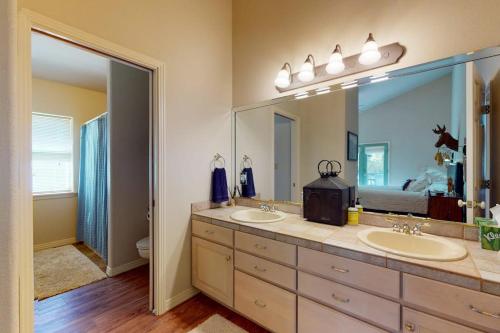 a bathroom with two sinks and a large mirror at Two Rivers Retreat in South Fork