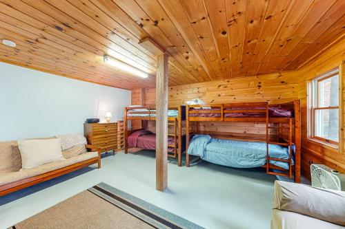 a room with two bunk beds in a cabin at The Red Camp in Casco