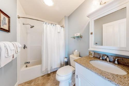 a white bathroom with a sink and a toilet at Sunset View in Wells