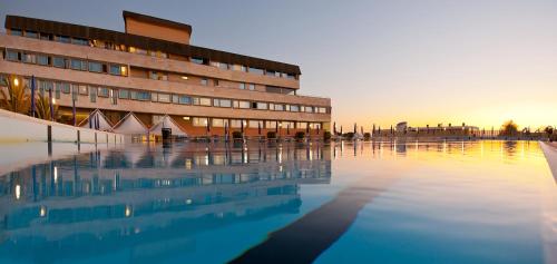 a building with a pool of water in front of it at Grand Hotel Continental in Tirrenia