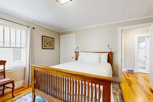 a bedroom with a bed and a chair and a window at Our Home on a Hill in Bethel