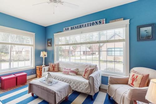 a living room with a couch and two windows at Wells Wonder in Wells