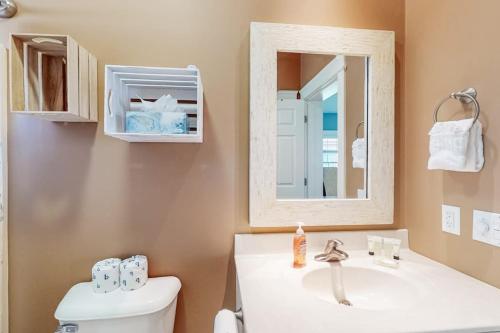 a bathroom with a sink and a toilet and a mirror at Wells Wonder in Wells