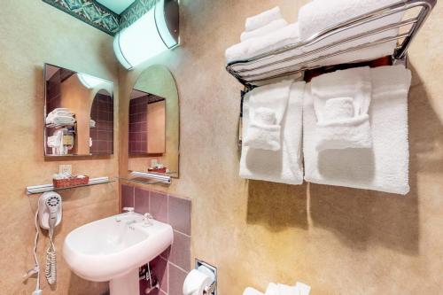 a bathroom with a sink and a mirror and towels at Shoshone 1993 in Big Sky