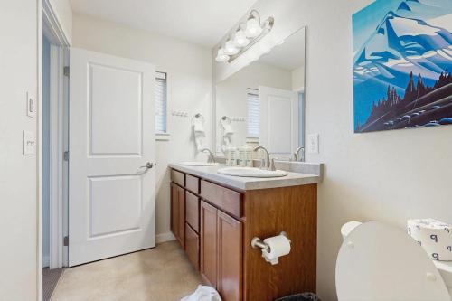 a bathroom with a sink and a toilet and a mirror at Morning Sun 2061B in Big Sky