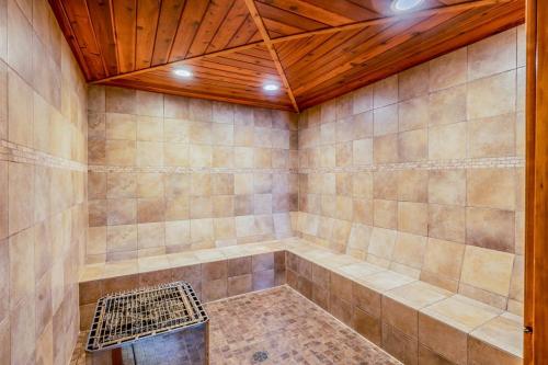a room with a tub with a wooden ceiling at Ptarmigan in Whitefish