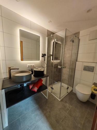 a bathroom with a sink and a shower and a toilet at Haus Resi in Berwang
