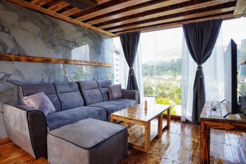 a living room with a couch and a table at Sameer Mountain View Cottage in Tanah Rata