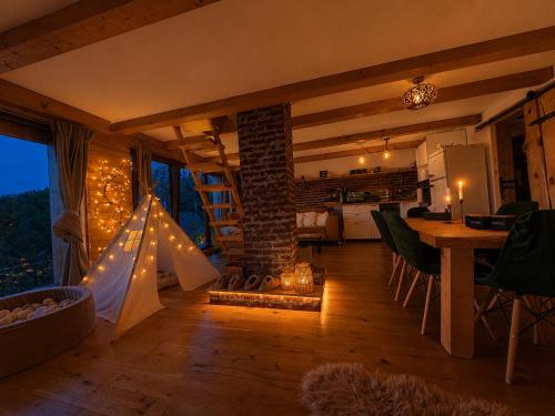 a kitchen and living room with a fireplace in a house at Chata Malenovice in Malenovice