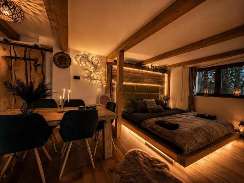 a bedroom with a bed and a table and a couch at Chata Malenovice in Malenovice