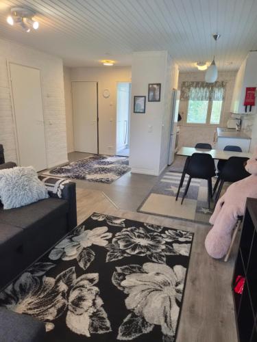 a living room with a couch and a table at Home nest in Seinäjoki