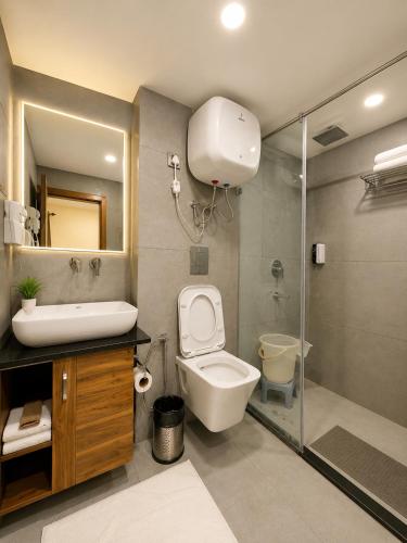 a bathroom with a toilet and a sink and a shower at The Moksh DA Hotel A Premium Property Near Jaypee Hotel in Mussoorie