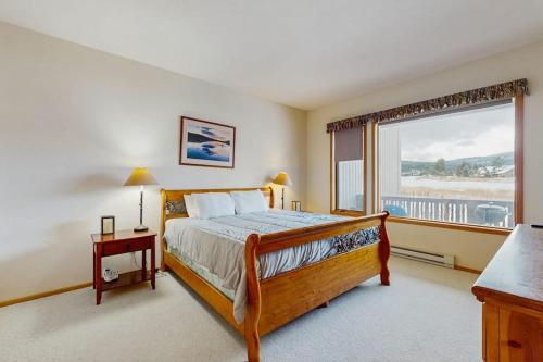 a bedroom with a bed and a large window at Park 282 in Big Sky