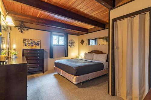 a bedroom with a bed and a dresser in it at Hilltop Hideaway in Bigfork