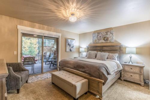 a bedroom with a bed and a sliding glass door at 7th Fairway Getaway in Columbia Falls