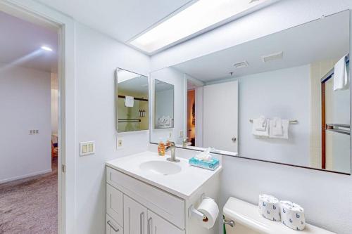 a white bathroom with a sink and a mirror at The Bridges 102 in Mammoth Lakes
