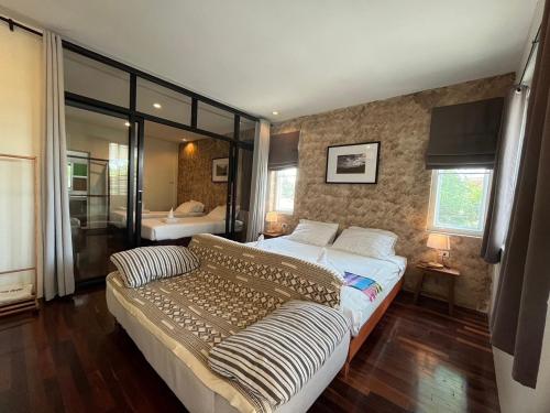 a bedroom with a large bed in a room at UDEE Cozy Hotel in Chiang Mai