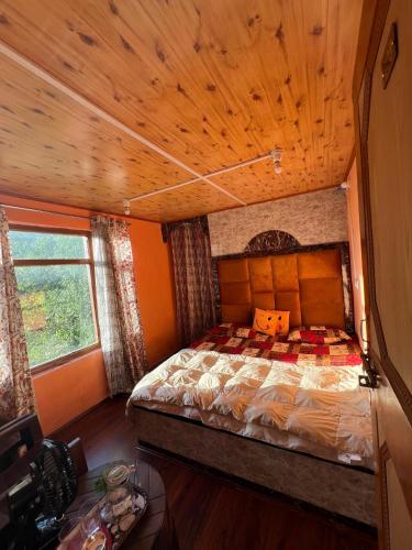 a bedroom with a bed with a wooden ceiling at Crown royal shahjee stay in Rezan