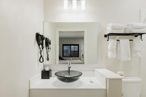 a bathroom with a sink and a mirror at SureStay by Best Western Morgan Hill in Morgan Hill